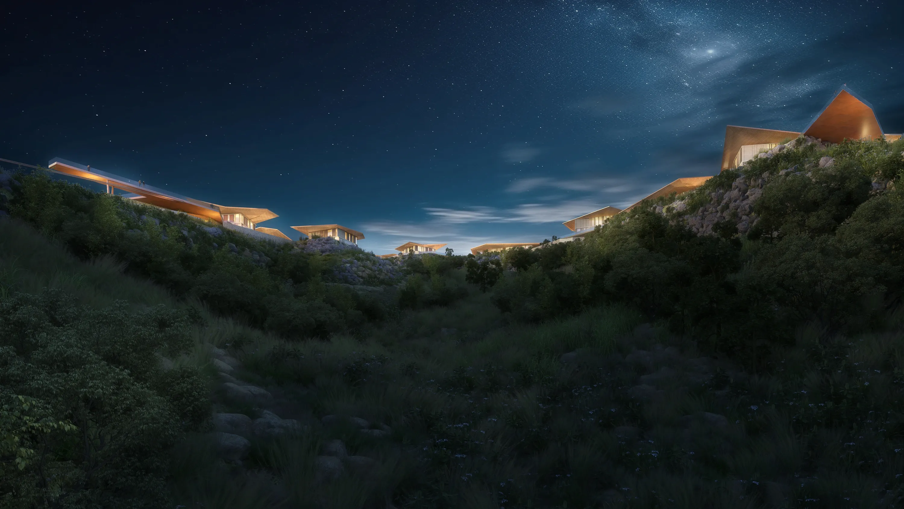 Mira Verde residences lit along the ridge under a night sky