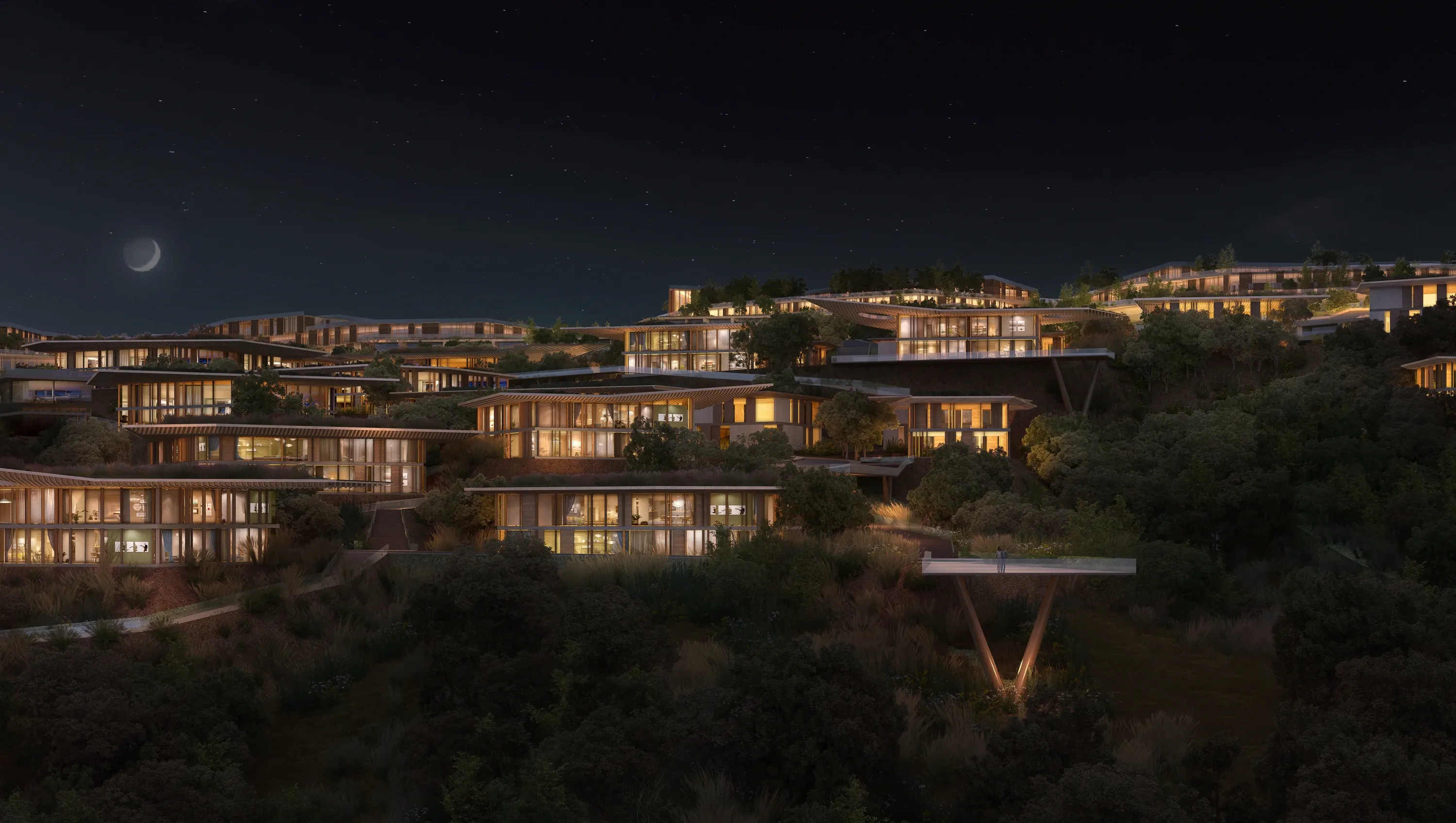 Terraced Mira Verde residences with lit interiors at night