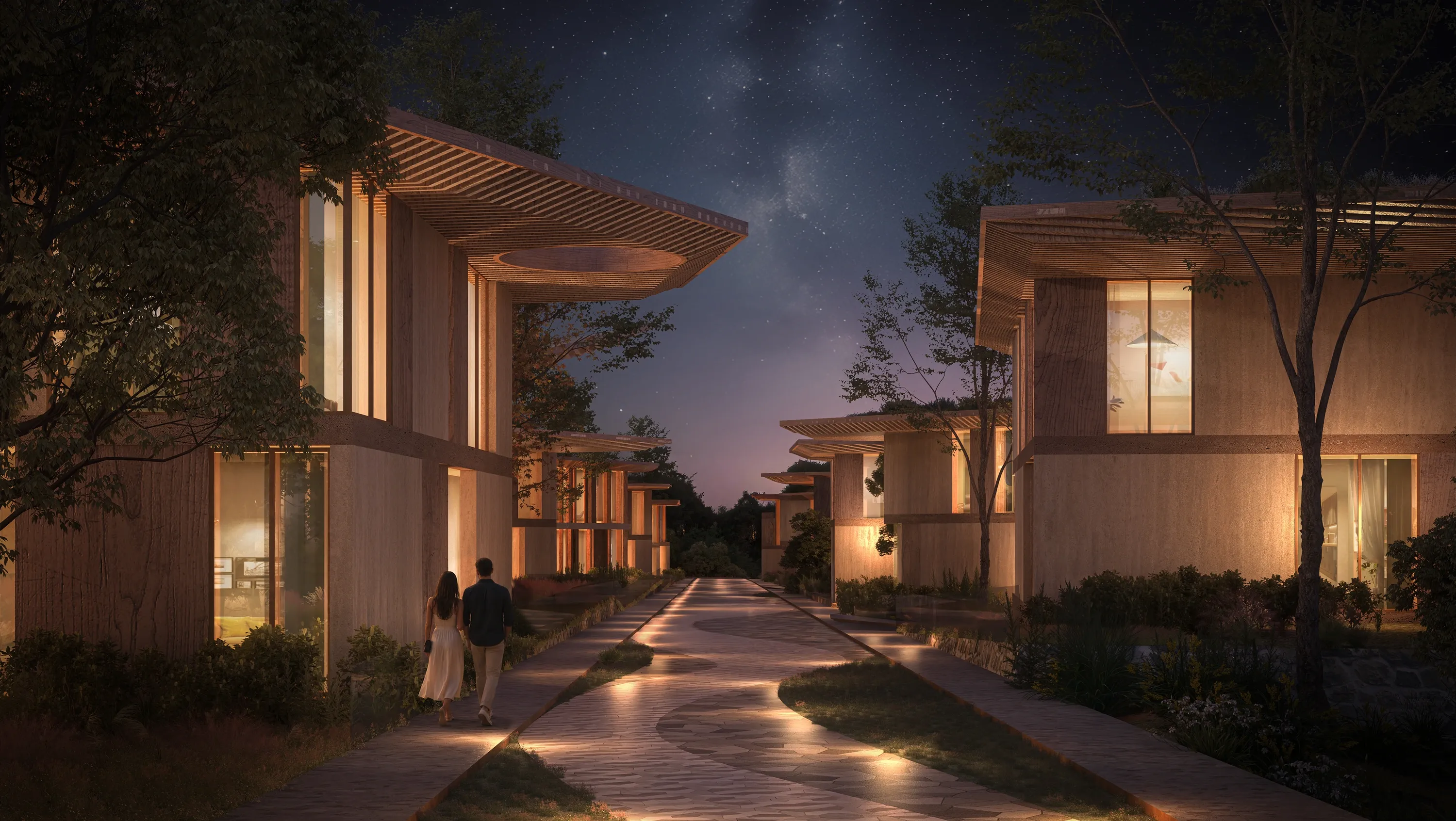 A lit pedestrian lane between Mira Verde townhouses in the evening